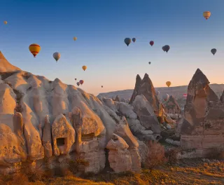 Hot air balloons rising up in the sky, in Cappadocia, Turkey.